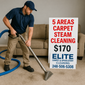 Professional carpet cleaner steam cleaning a beige carpet in a living room beside a large sign advertising “5 Areas Carpet Steam Cleaning $170” for Elite Carpet & Upholstery Cleaning with the phone number 248-506-5308.